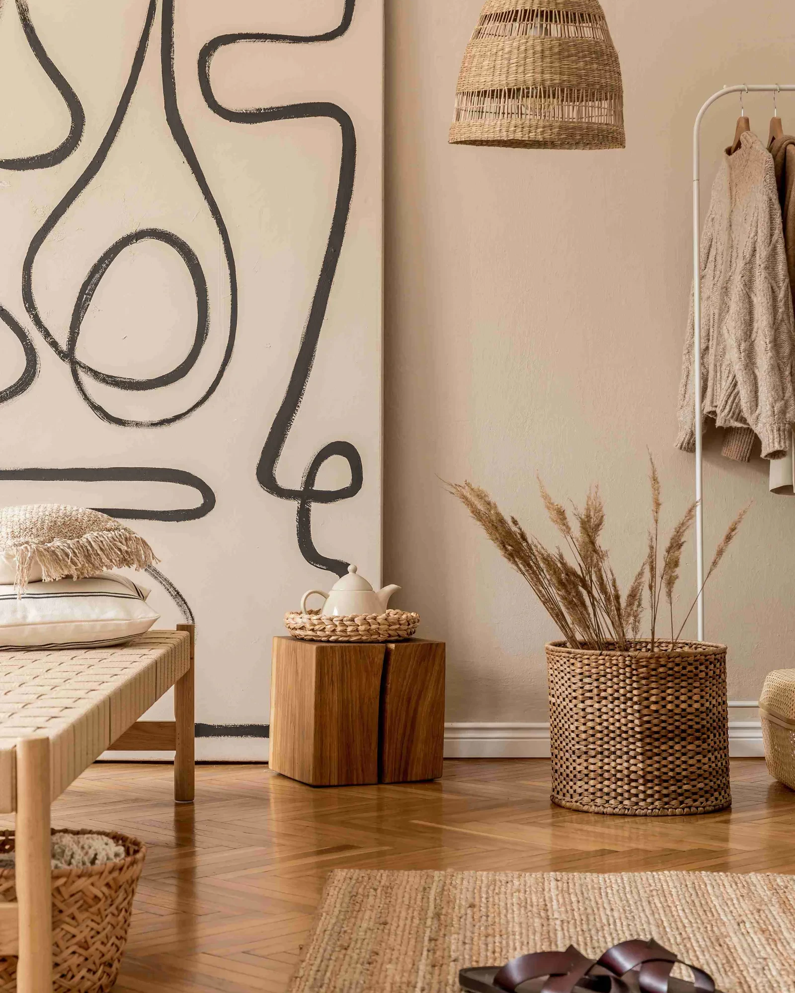 A calm bedroom corner with a line-drawn artwork and natural textures